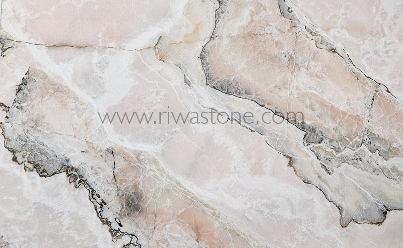 Natural Pink Onyx slab featuring soft blush pink, ivory crystalline formations and subtle grey mineral veins from Iran.