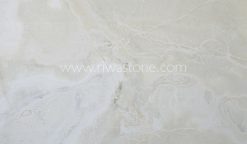 Ice Onyx slab featuring soft white translucent crystals with delicate ivory veining from Iran.