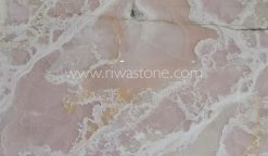 Pink Onyx slab featuring soft blush pink tones, flowing white crystalline veins and natural translucent beauty from Iran.